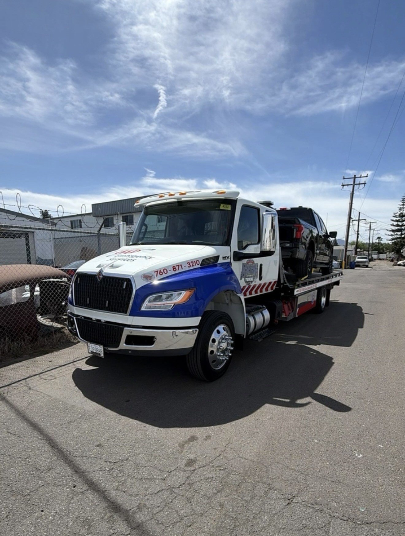 Johnathan's Towing flatbed and wrecker trucks parked in St. Louis