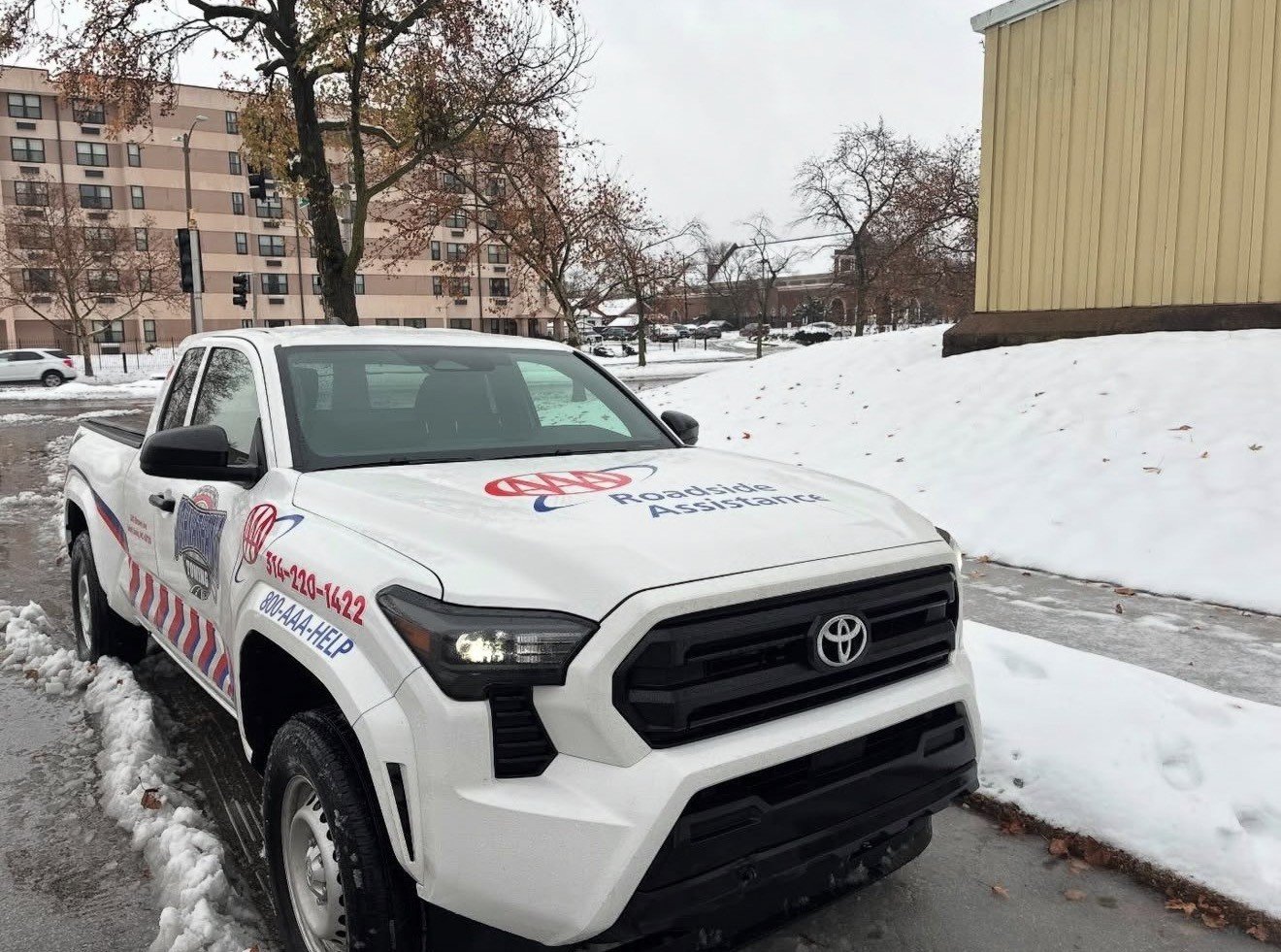 AAA roadside assistance truck working in the snow in St. Louis