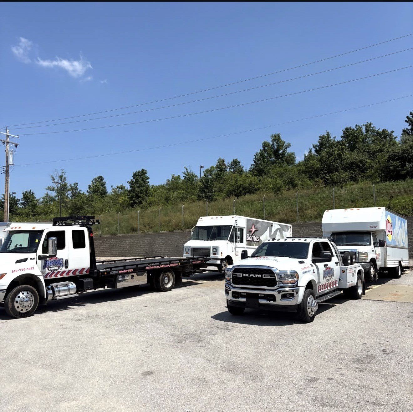 Sprinter van being towed by a Johnathan's Towing flatbed